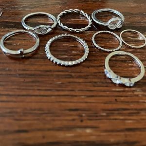 8 silver rings, multiple sizes and designs from a set off Amazon